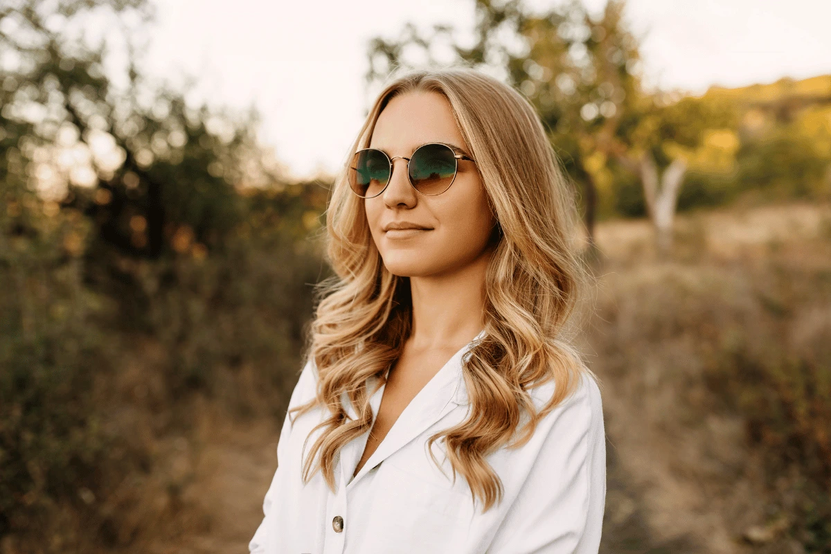 a woman outdoors wearing sunglasses